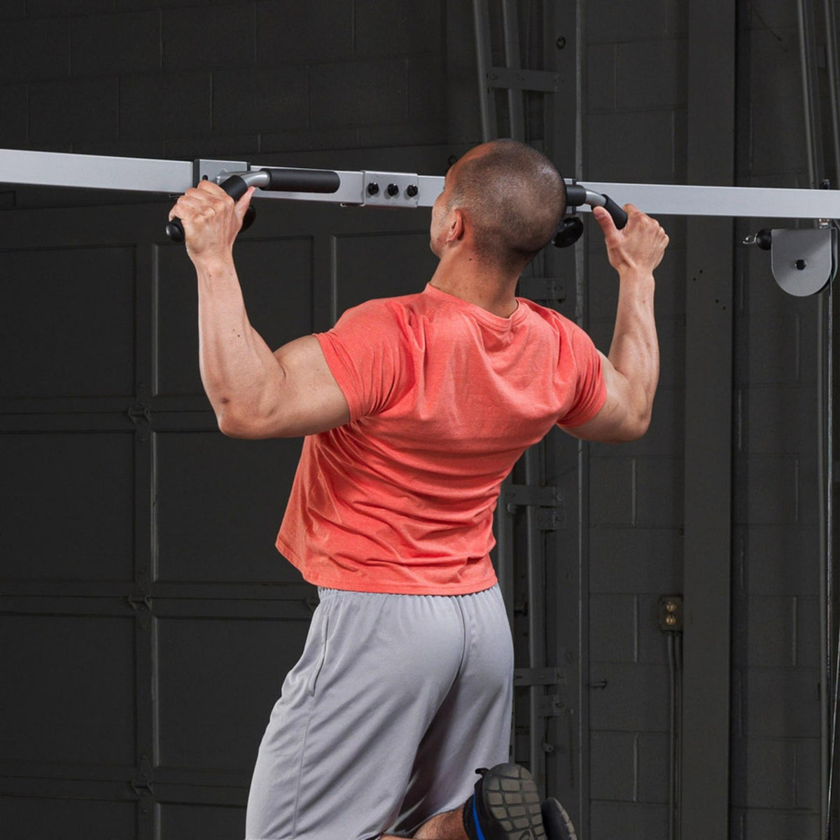 Body-Solid Cable Crossover Pull Up Attachment GCA2 performing pull up a man Back side view