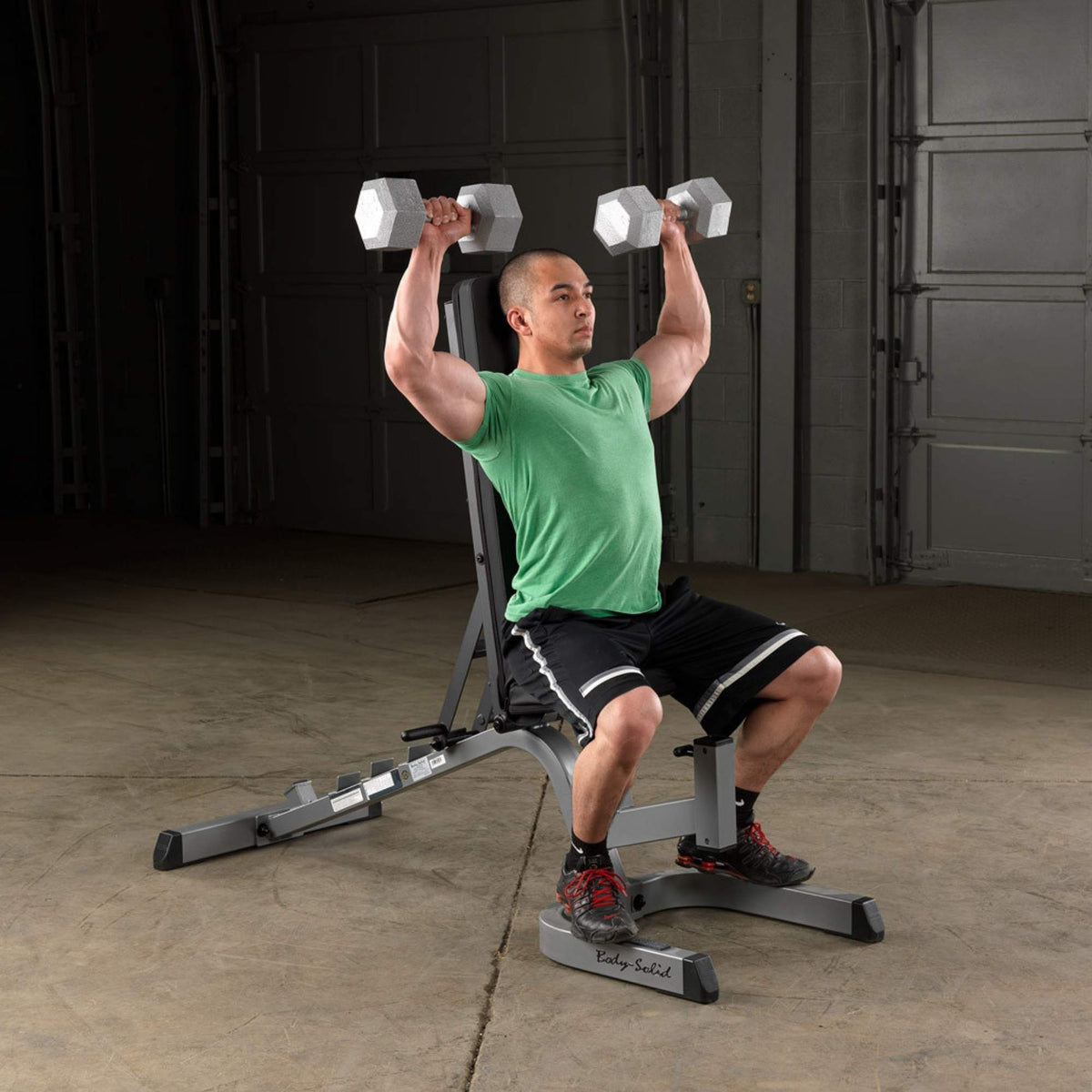 Body-Solid Flat Incline Decline Bench GFID71B Man doing shoulder press on Body-Solid adjustable bench with dumbbells