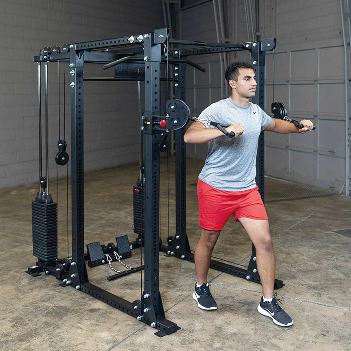 Body-Solid Functional Trainer Attachment with Weight Stacks GPRFTS man performing Fly Chest exercise