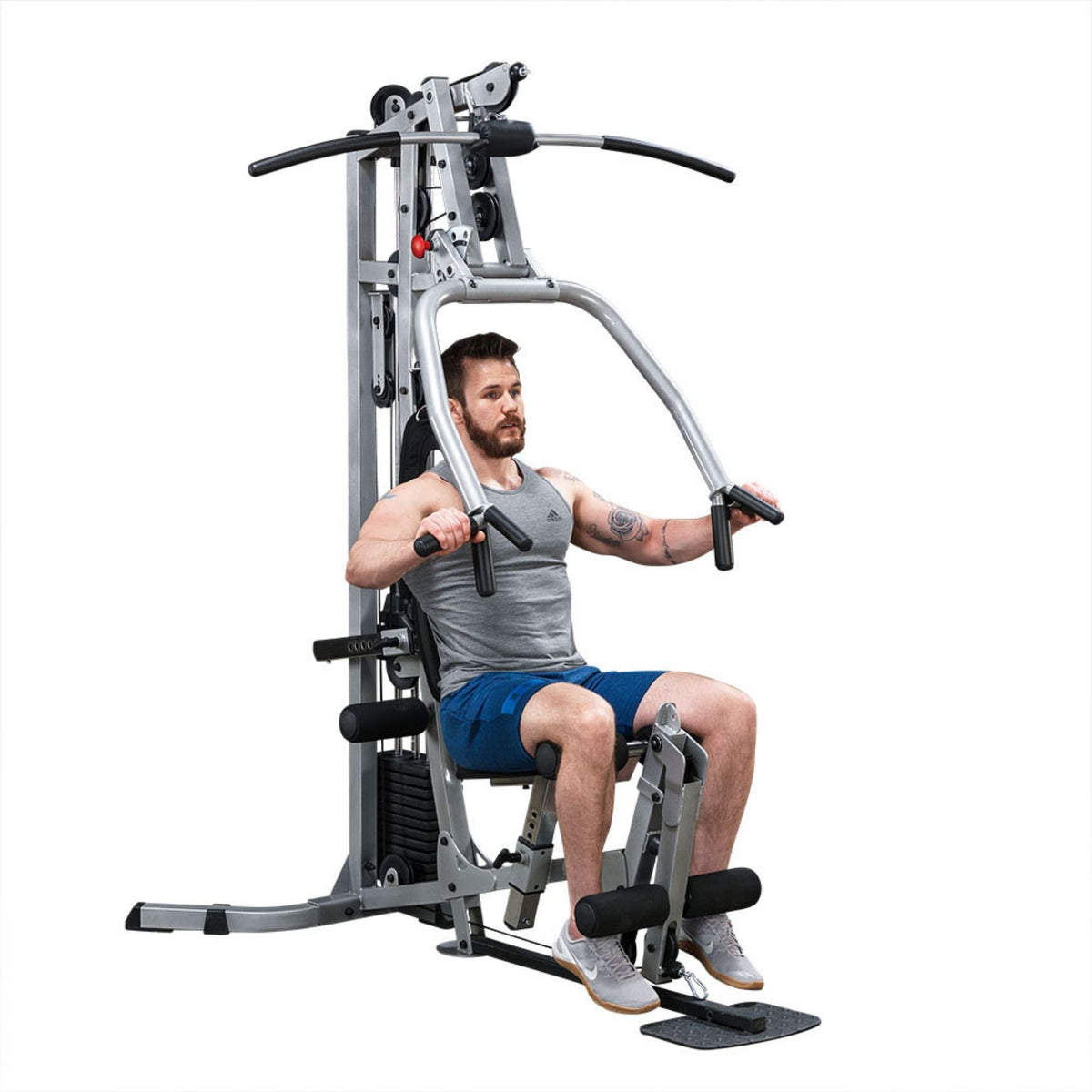 Body-Solid Powerline Multi-Station Home Gym BSG10X Man seated and pressing handles on a Body-Solid home gym machine, highlighting upper body workout capabilities