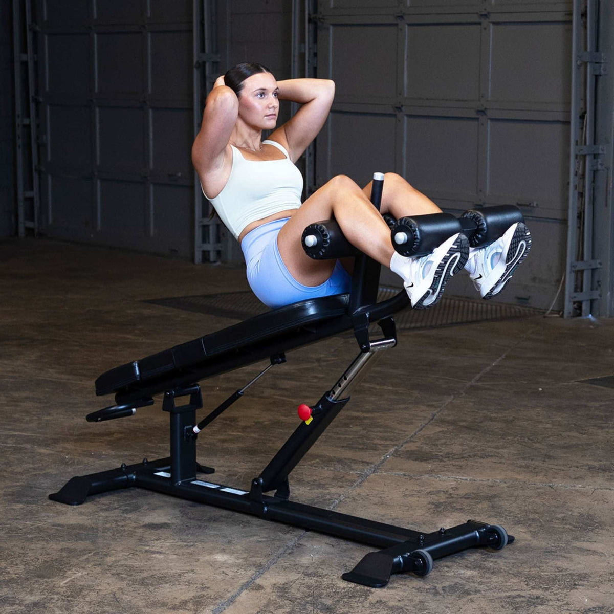 Body-Solid Proclub Commercial Ab Bench SAB500B Woman performing sit-ups on an adjustable decline bench