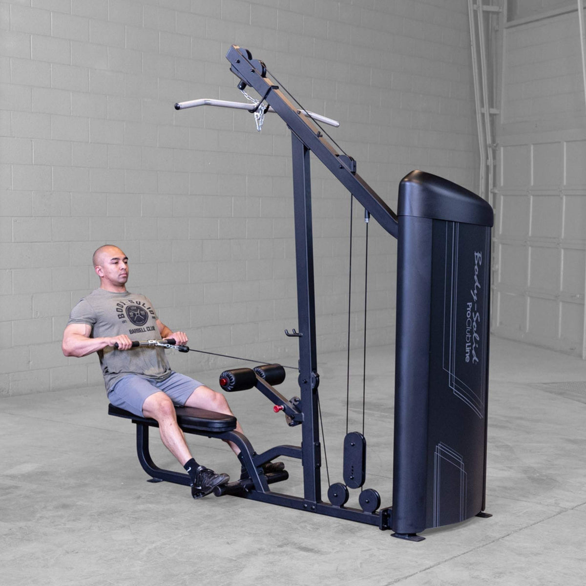 Body-Solid Series 2 Lat Mid Row S2LATX Man performing wide-grip seated row exercise on Body-Solid ProClub Line lat pulldown and low row combo machine