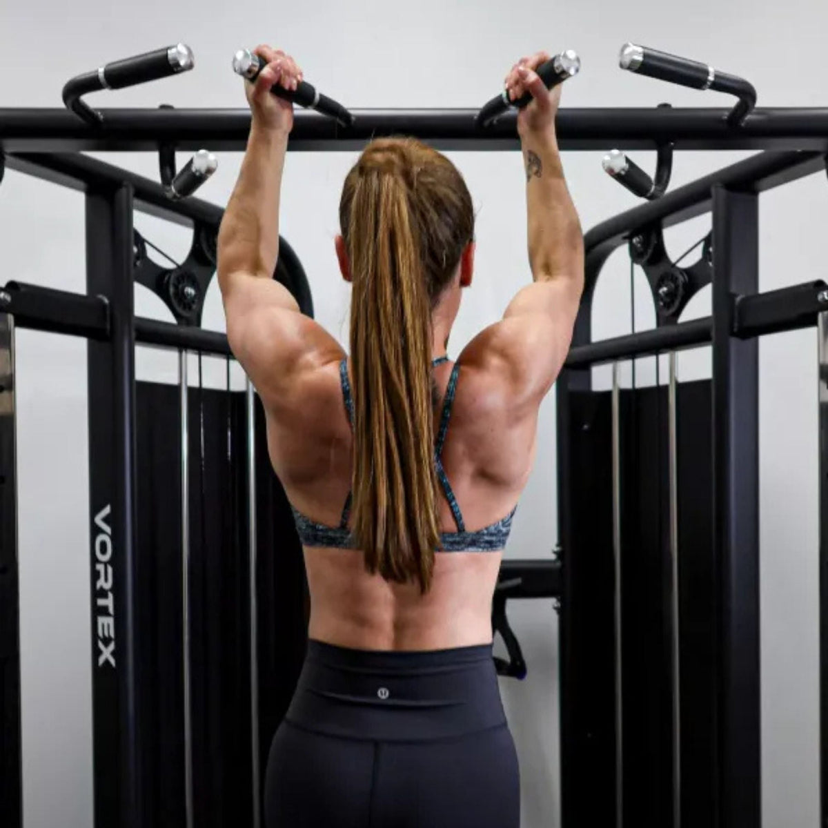 Vortex Functional Trainer, Double Stack 160LB Cable Pull Station Trainer VX500 Woman doing pull-ups on trainer
