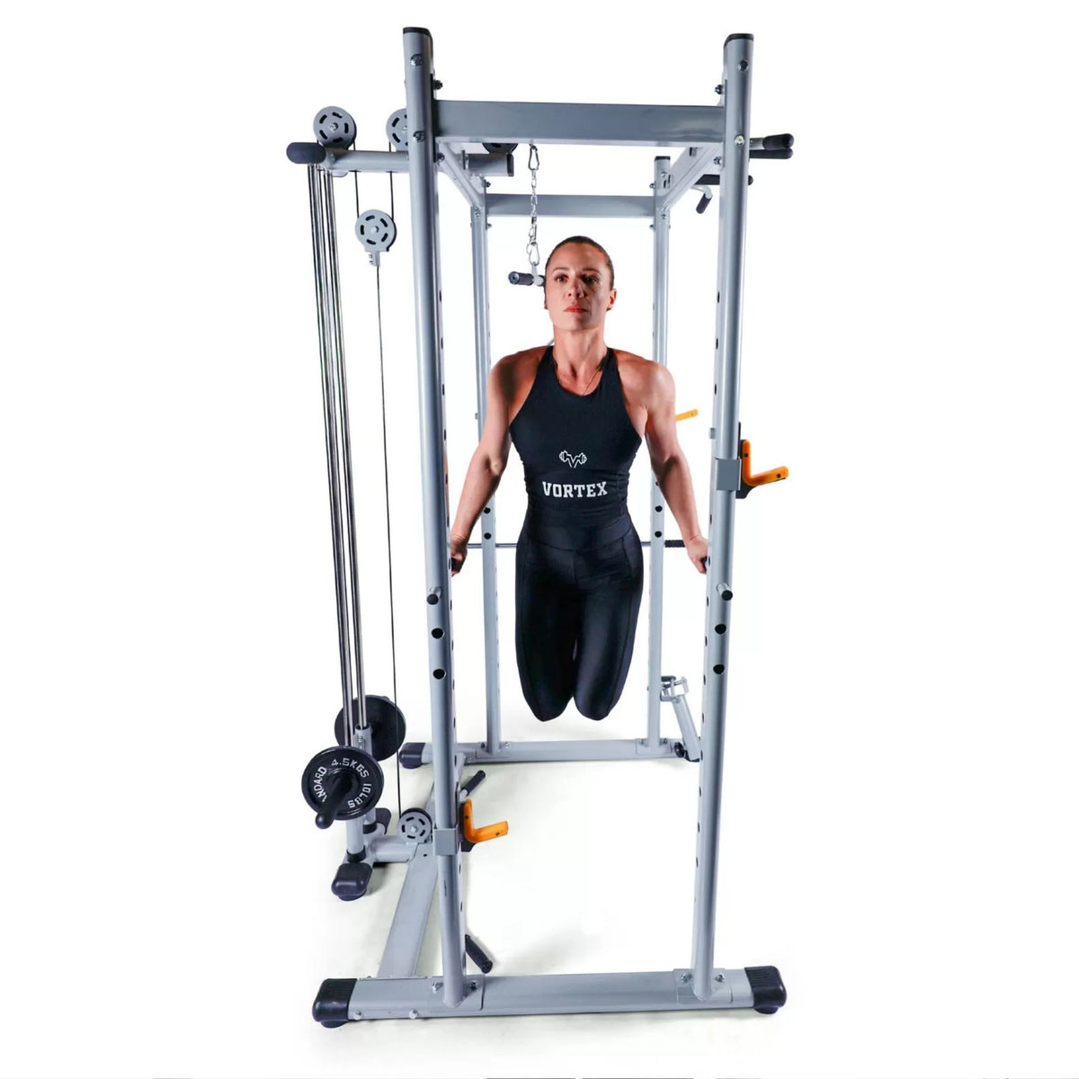 Vortex Squat Cage With High/low Pulley, Dip Attachments and Landmine SRVXG350 Woman performing bodyweight dips inside functional Smith machine with dip handles attached