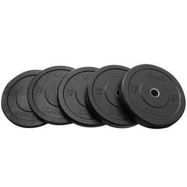 A set of black TKO bumper plates with steel inserts arranged in a row