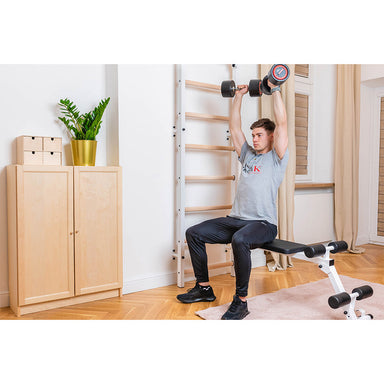 BenchK Wall Bar Home Gym 723W with male exercising with dumbbells on bench