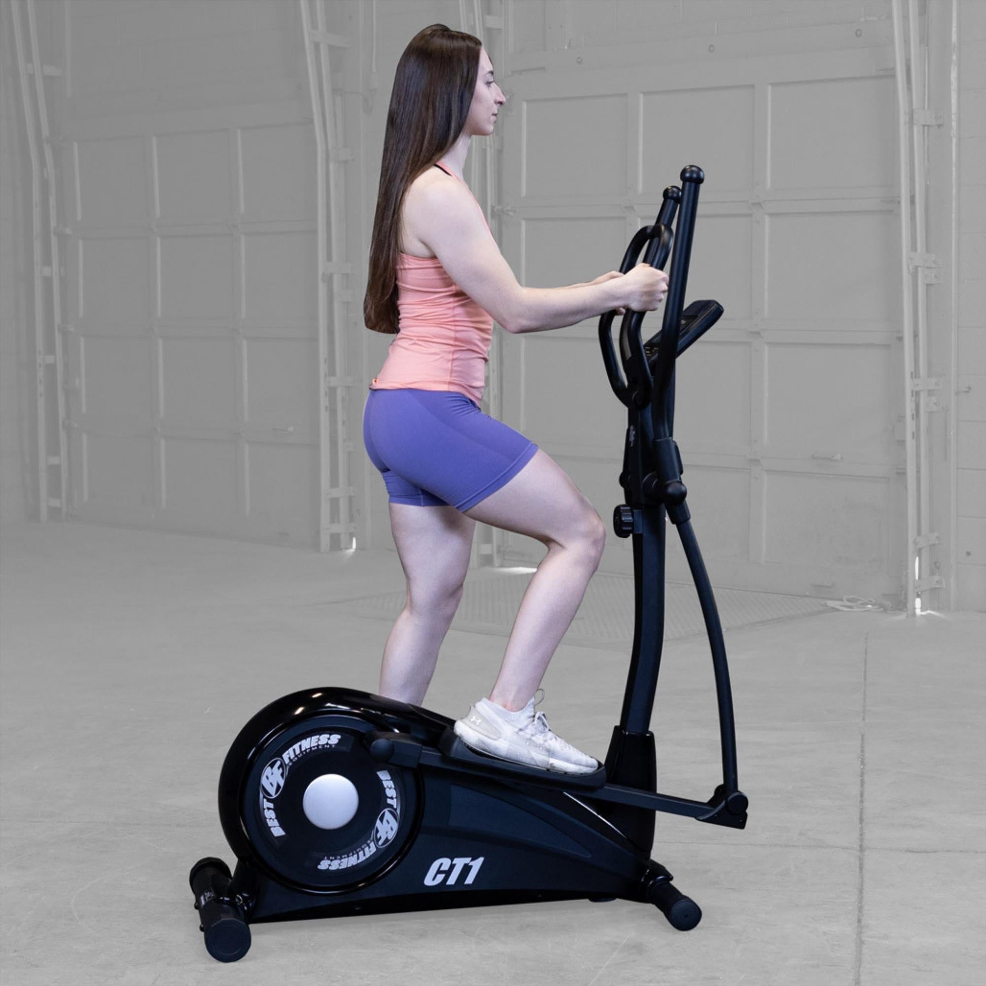 Best Fitness Cross Trainer Elliptical BFCT1B Side view of woman pedaling on Best Fitness CT1 elliptical machine during home gym workout.

