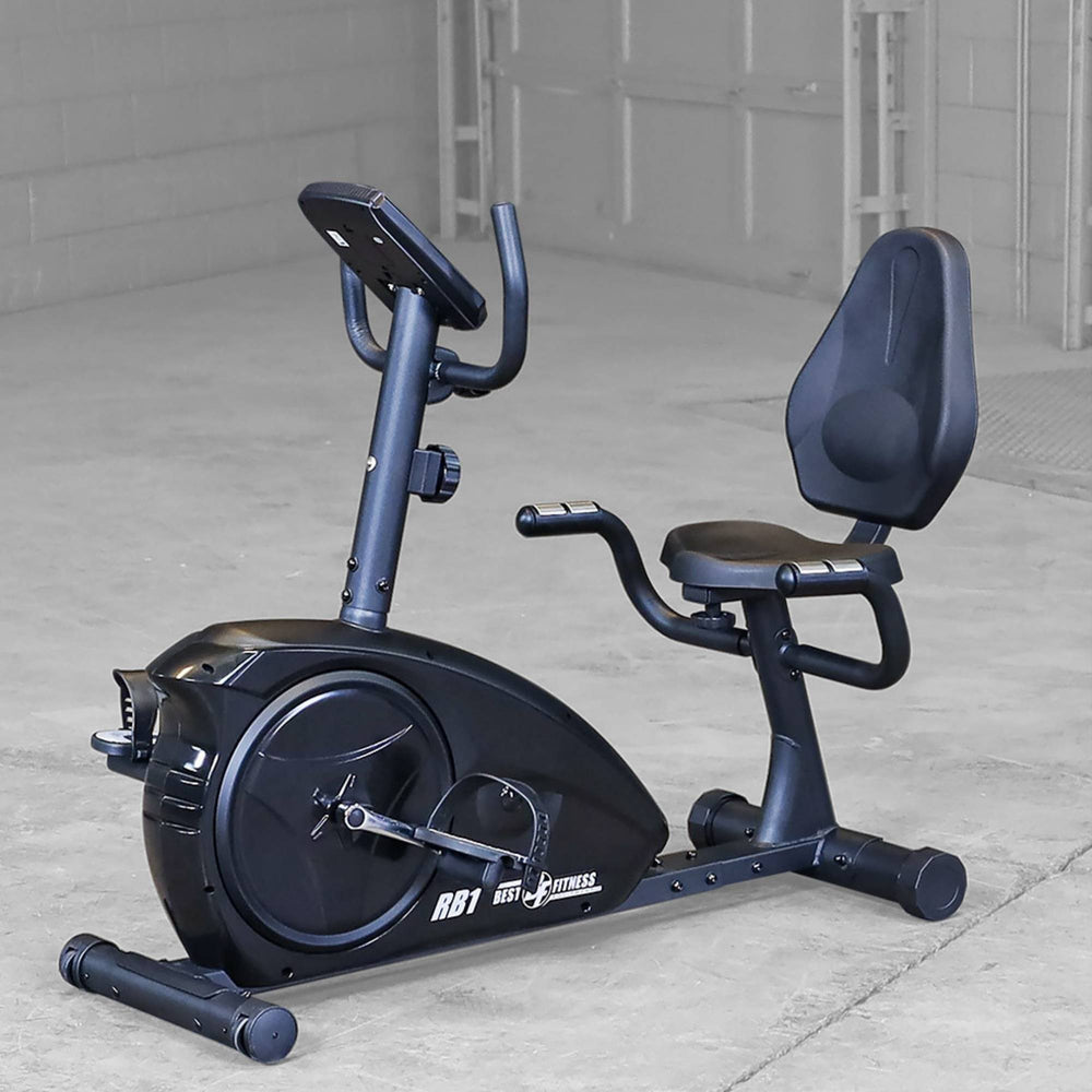 Best Fitness Recumbent Bike BFRB1B Best Fitness RB1 recumbent bike positioned in a minimalist home gym setting with concrete floor.