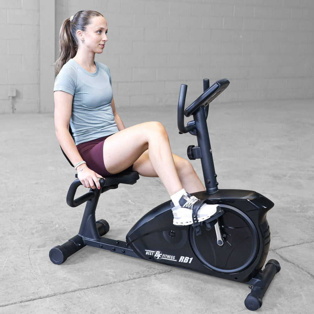 Best Fitness Recumbent Bike BFRB1B Woman pedaling Best Fitness RB1 recumbent exercise bike during a low-impact cardio session.