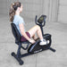 Best Fitness Recumbent Bike BFRB1B Woman using Best Fitness RB1 recumbent exercise bike during a workout, pedaling with proper posture.
