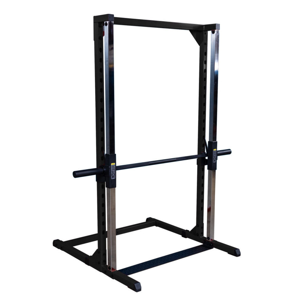 Best Fitness Smith Machine BFSM250B  Body-Solid Smith machine with barbell set in safety position on polished chrome rails in gym