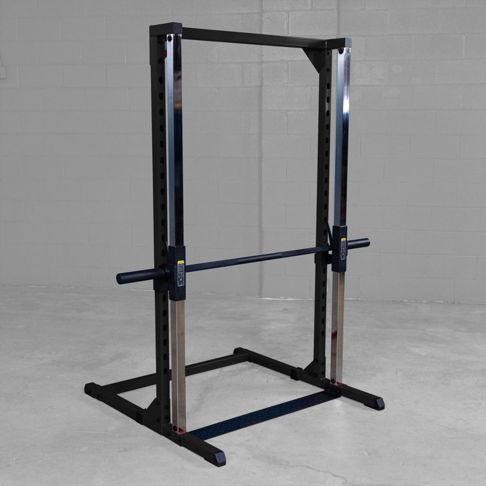 Best Fitness Smith Machine BFSM250B Body-Solid Smith machine with chrome guide rods and safety bar in industrial gym setting.