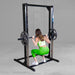 Best Fitness Smith Machine BFSM250B Woman performing deep squat using Body-Solid Smith machine with barbell and weight plates.