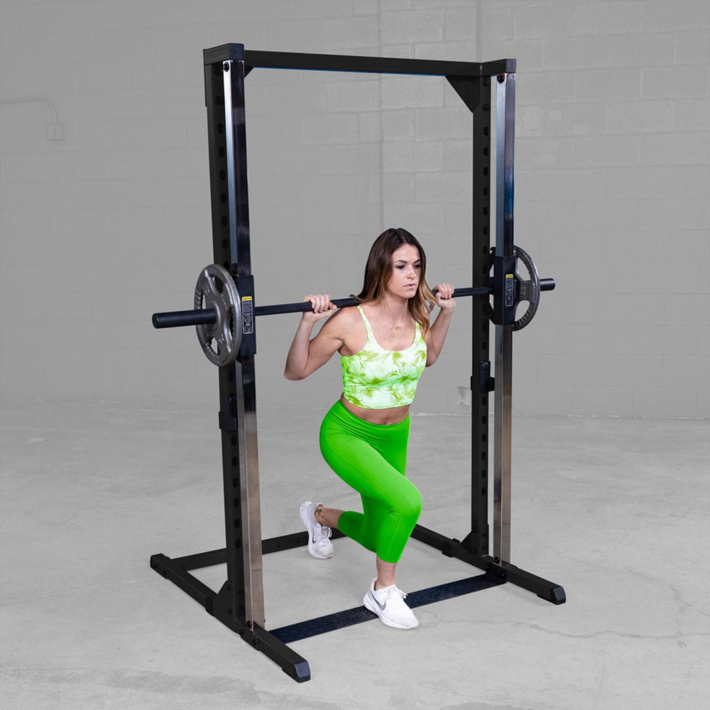 Best Fitness Smith Machine BFSM250B Woman performing stationary lunge exercise using Body-Solid Smith machine for lower body training.
