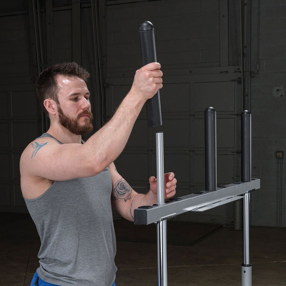 Man assembling a Body-Solid 14" Olympic Adapter Sleeve OAS14