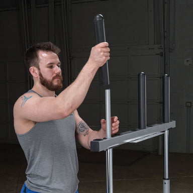 Man assembling a Body-Solid 14" Olympic Adapter Sleeve OAS14