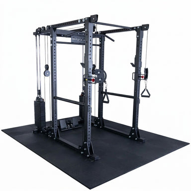 A black multi-functional home gym power rack with cable pulleys, weight plates, and a large black rubber mat base, shown on a solid white background.