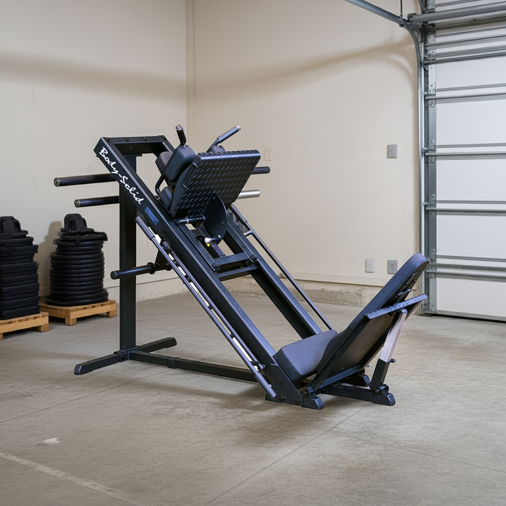 Body-Solid GLPH1100B Leg Press Hack Squat in a gym warehouse setting with pallets and closed garage door.