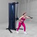 Body-Solid-S2CC-Series-2-Cable-Column-Single-Arm-Cable-Chest-Fly. Woman exercising on a fitness machine in a studio setting