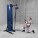 Body-Solid-S2CC-Series-2-Cable-Column-Single-Arm-Kneeling-Cable-Lat-Pulldown. Person using a cable machine in a gym setting. 