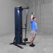 Body-Solid-S2CC-Series-2-Cable-Column-Single-Arm-Overhead-Cable-Triceps-Extension. Person using a cable machine in a gym setting
