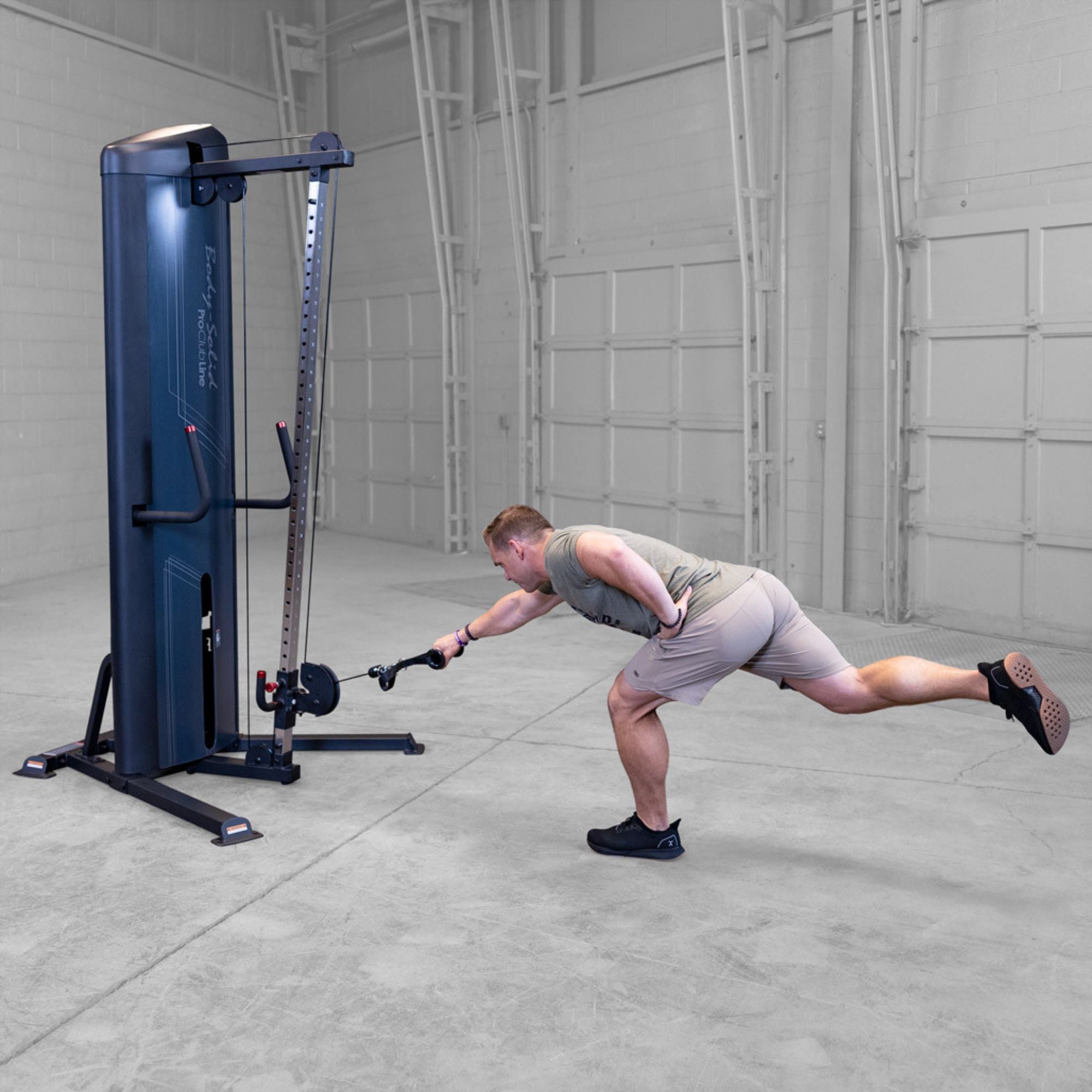 Body-Solid-S2CC-Series-2-Cable-Column-Single-Leg-Cable-Row. Man exercising on a cable machine in a gym setting