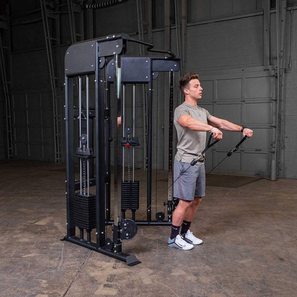 Man doing front chest raises with a Body-Solid Functional Trainer GFT100