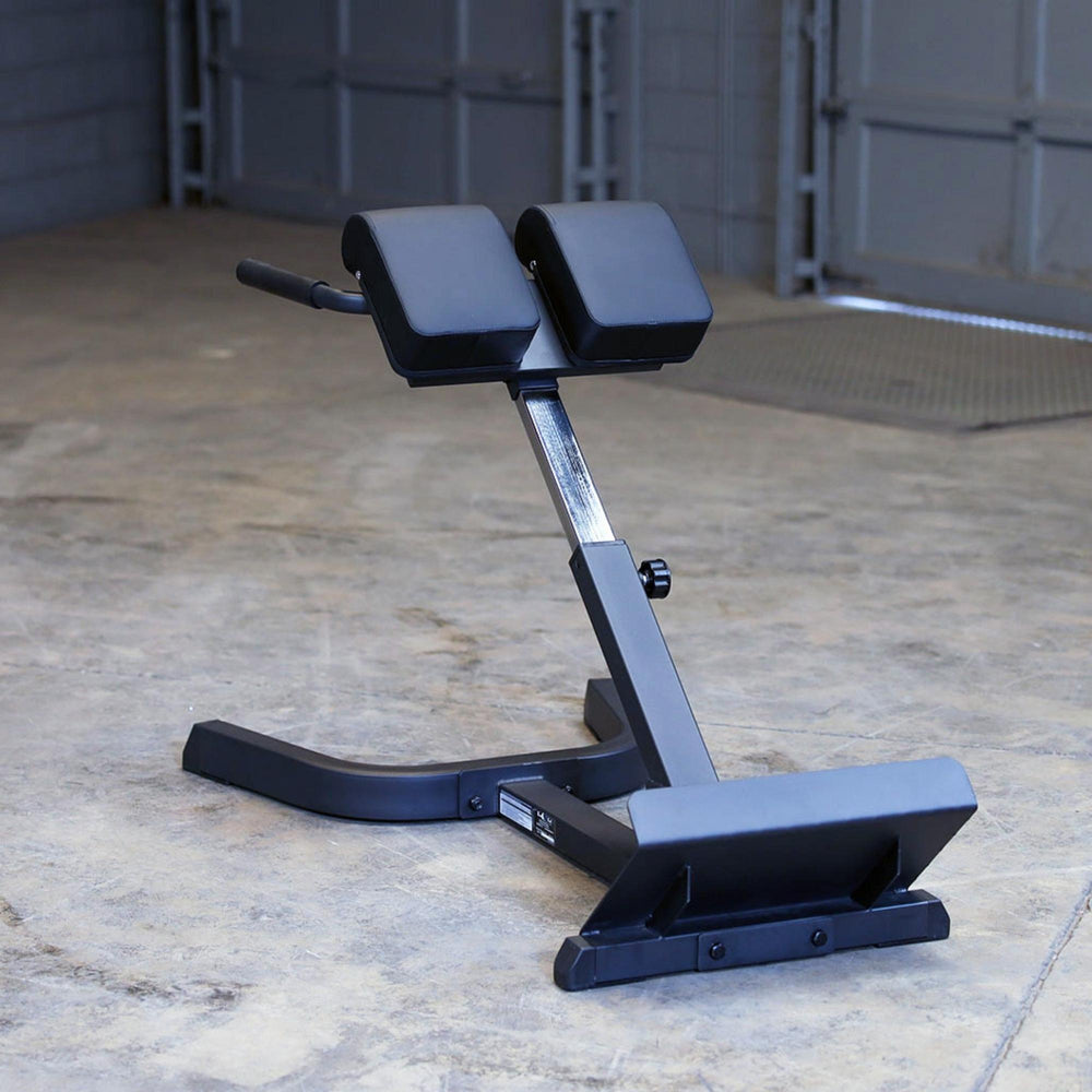 Body-Solid 45 Back Hyperextension GHYP345B Rear view of hyperextension bench showing adjustable support column and foot brace