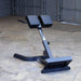 Body-Solid 45 Back Hyperextension GHYP345B Rear view of hyperextension bench showing adjustable support column and foot brace