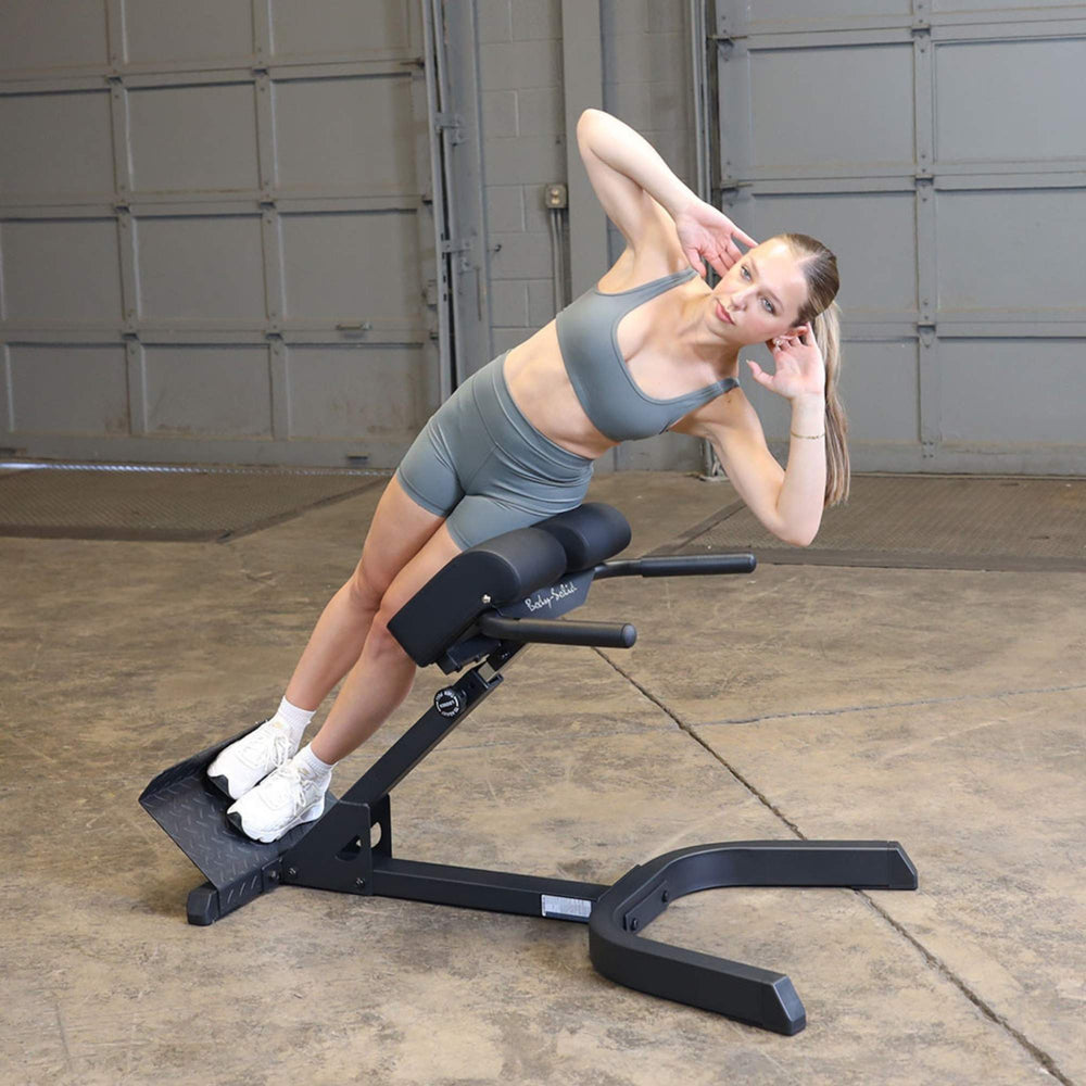 Body-Solid 45 Back Hyperextension GHYP345B Woman performing side bend exercise for obliques