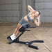 Body-Solid 45 Back Hyperextension GHYP345B Woman performing side bend exercise for obliques