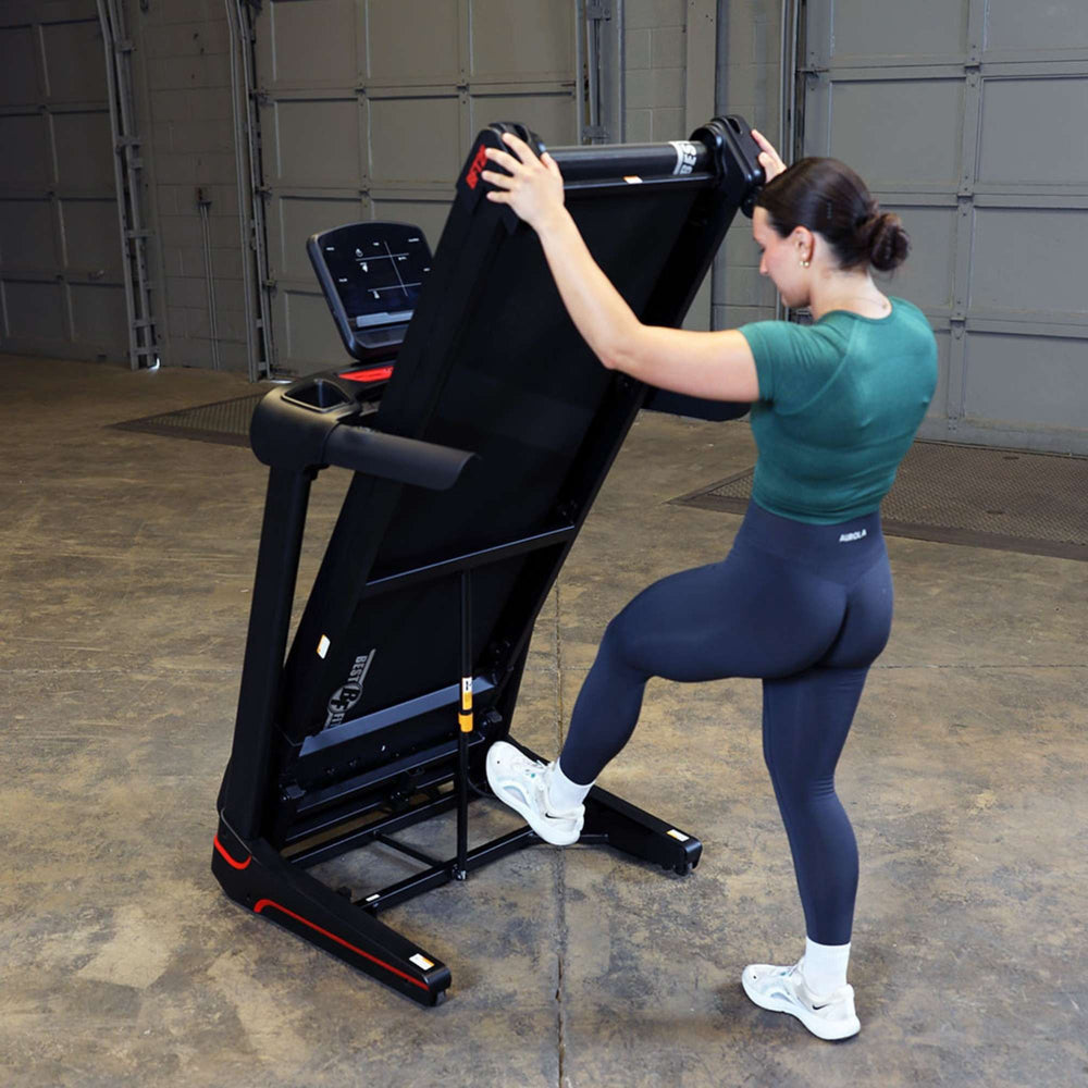Body-Solid Best Fitness Folding Treadmill With LED Console BFT25 Woman folding Best Fitness treadmill for space-saving storage
