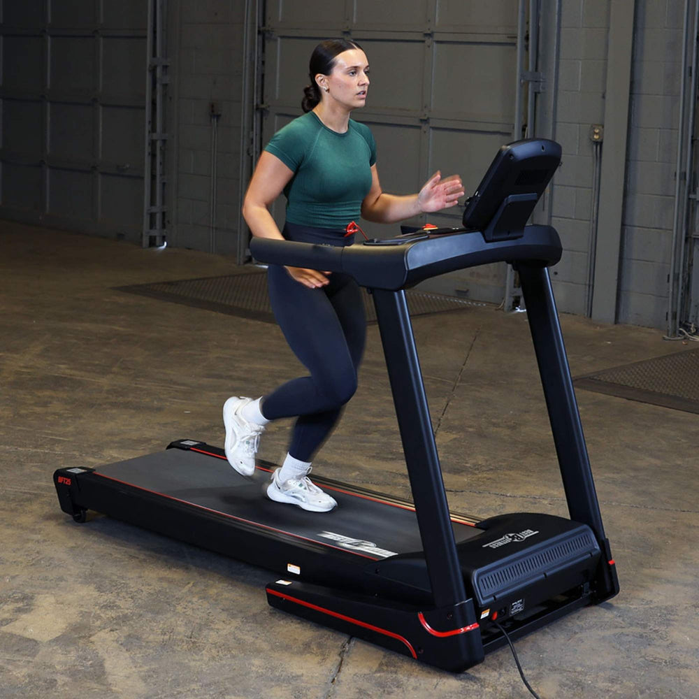 Body-Solid Best Fitness Folding Treadmill With LED Console BFT25 Woman running on Best Fitness treadmill for indoor cardio training