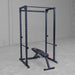Body-Solid Best Fitness Power Rack BFPR100B Empty black power rack with adjustable bench positioned inside a spacious gym setup.


