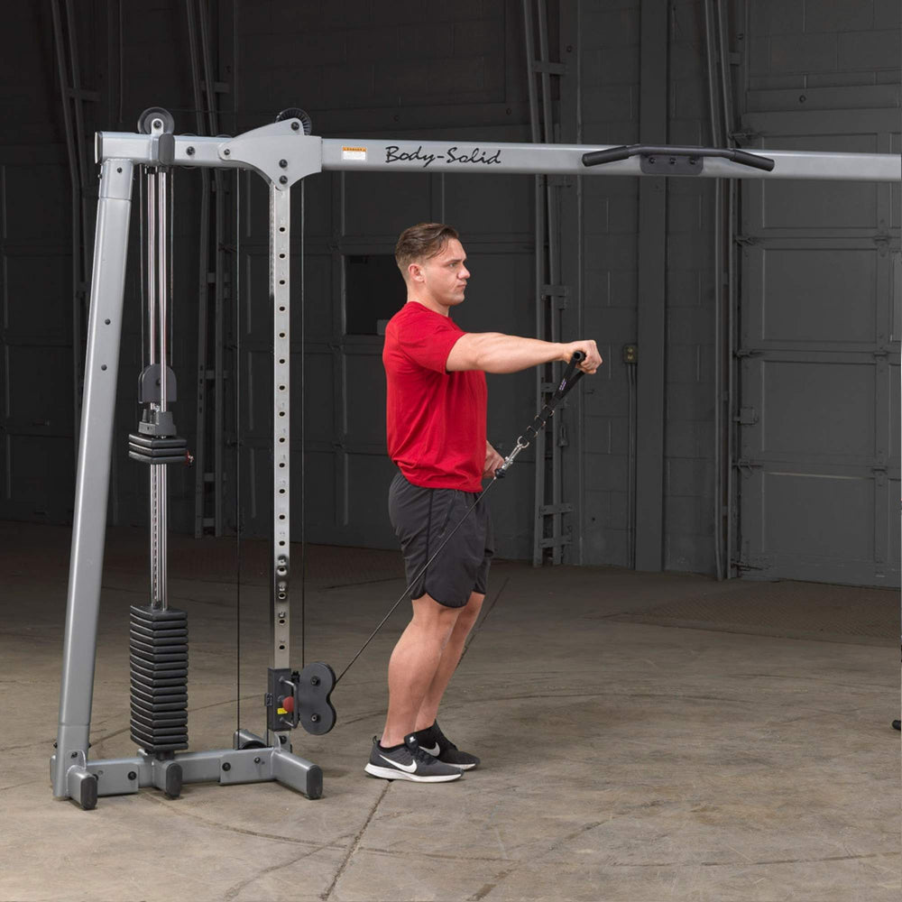 Body-Solid Cable Crossover GDCC250B Man doing front shoulder raise on  adjustable cable machine