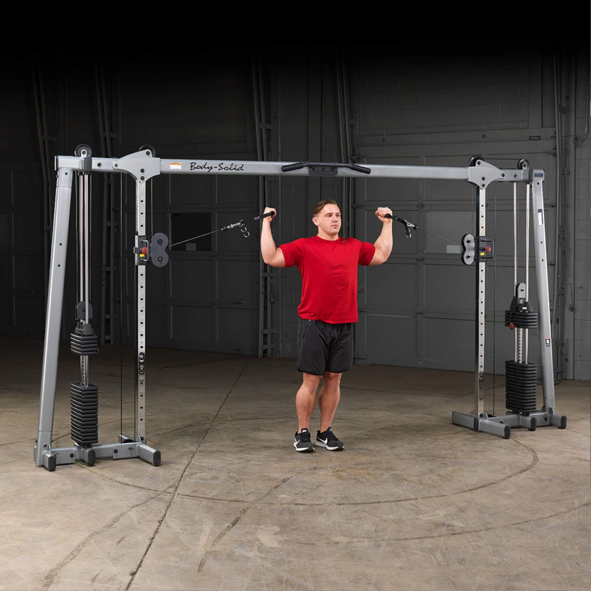 Body-Solid Cable Crossover GDCC250B Man doing shoulder press on  functional cable crossover system