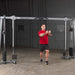 Body-Solid Cable Crossover GDCC250B Man performing chest fly workout 