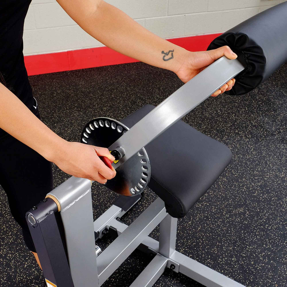 Body-Solid Cam Series Ab & Back Machine GCAB360B Close-up of hand adjusting the arm angle selector on the Body-Solid ab machine