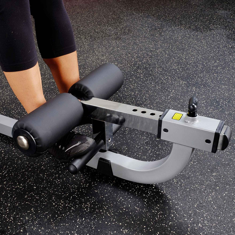 Body-Solid Cam Series Ab & Back Machine GCAB360B Close-up of padded foot rollers with adjustable settings on the Body-Solid ab machine