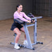 Body-Solid Cam Series Biceps & Triceps GCBT380B Woman beginning curl motion using preacher curl machine with proper form