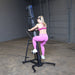 Body-Solid Climber Endurance CL300 Female athlete in pink workout set stepping on Body-Solid Endurance climber for cardio training

