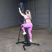 Body-Solid Climber Endurance CL300 Rear view of woman in pink gym wear starting session
