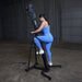 Body-Solid Climber Endurance CL300 Woman using Body-Solid vertical climber in blue activewear inside gym space