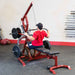 Body-Solid Corner Leverage Gym GLGS100B Back view of a man performing lat pulldown exercise on a red home gym machine with black weights.
