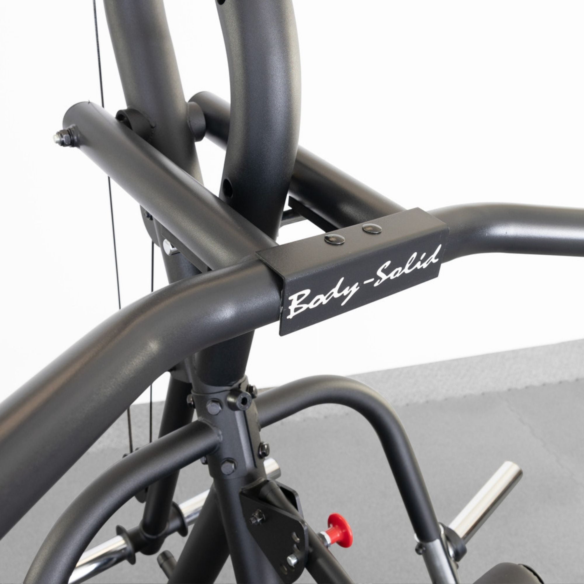 Body-Solid Corner Leverage Gym GLGS100B Top section of Body-Solid fitness machine highlighting upper frame logo and welded steel joints for durability.
