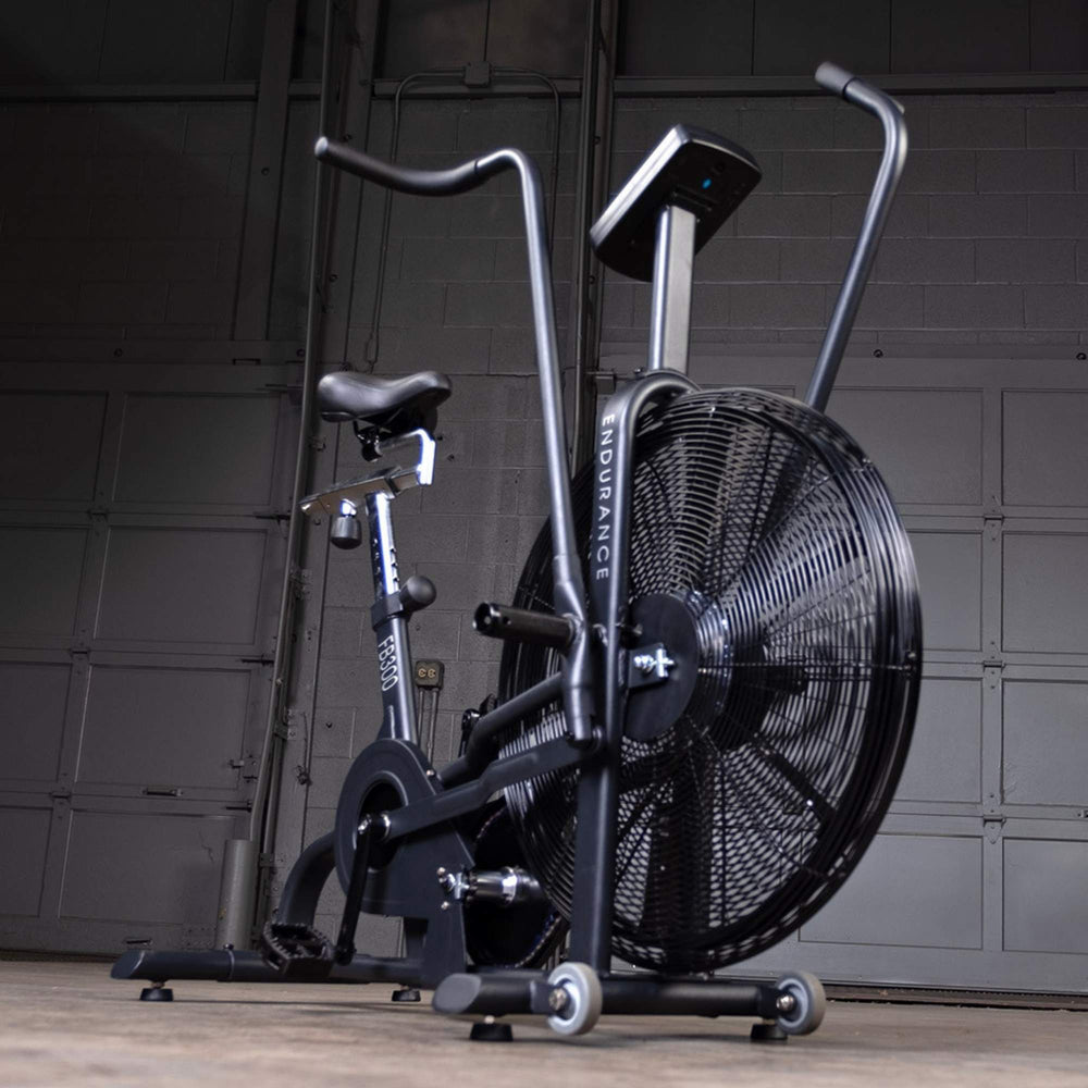 Body-Solid Endurance Dual Action Fan Bike FB300B Close-up low angle of FB300 air bike in industrial gym setting