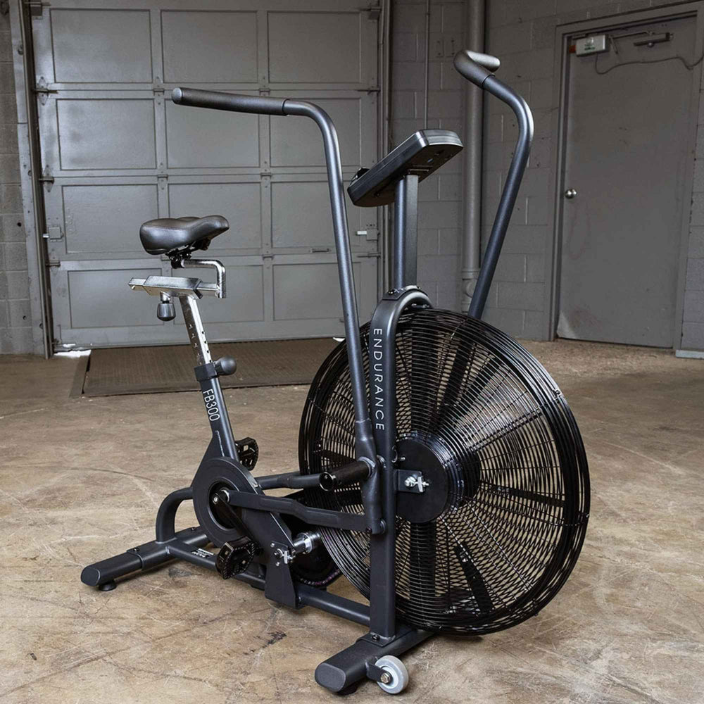Body-Solid Endurance Dual Action Fan Bike FB300B fan bike positioned in concrete-floor gym