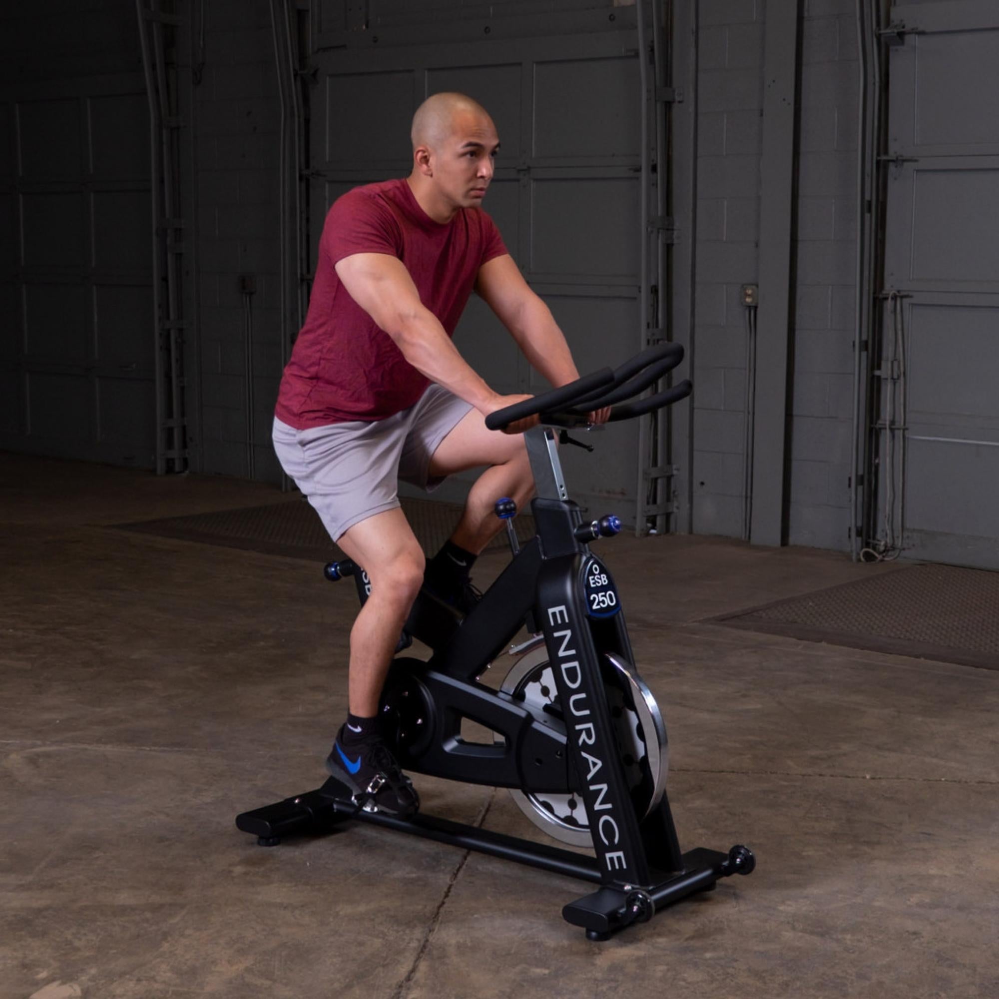 Body-Solid Endurance Indoor Cycle ESB250 Man pedaling on  spin bike during workout

