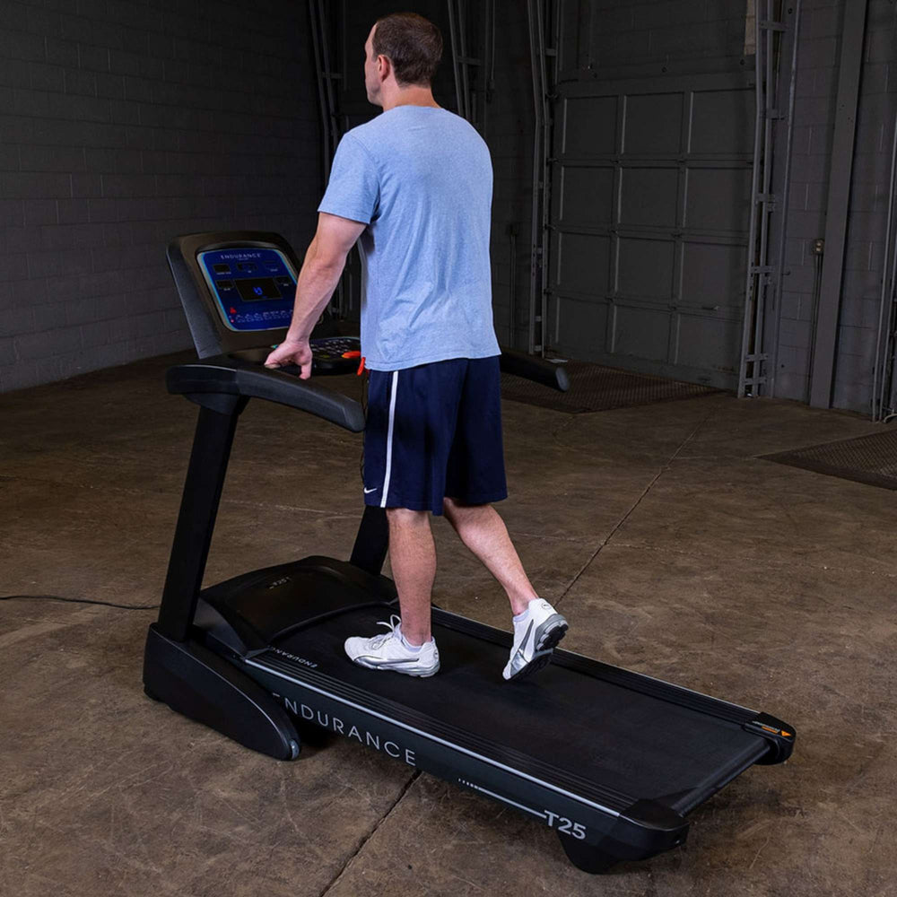 Body-Solid Endurance T25 Folding Treadmill T25 a man exercising back view