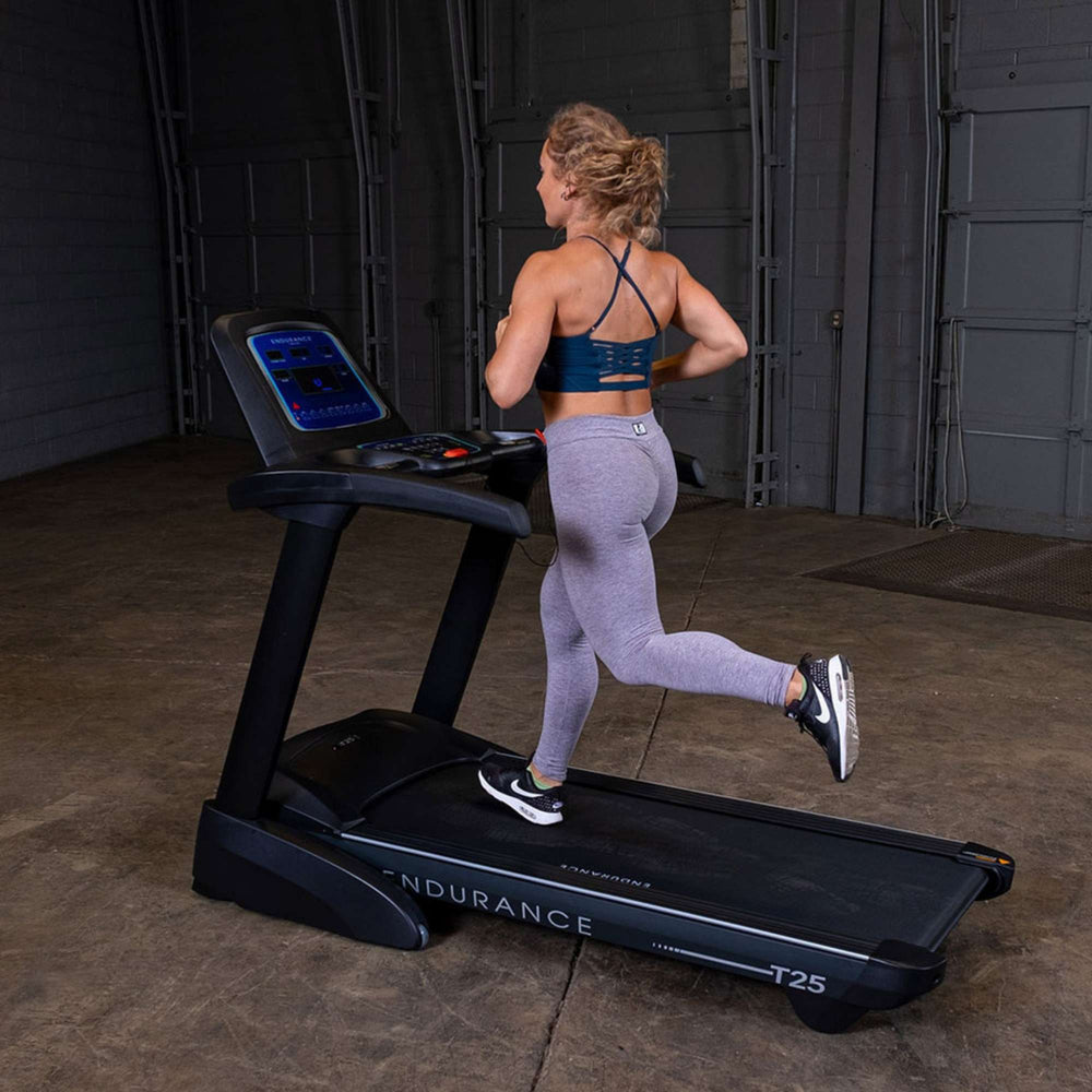 Body-Solid Endurance T25 Folding Treadmill T25 a woman exercising back view